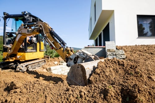 mini-excavator-digging-preparing-ground-under-home-2021-10-27-20-22-43-utc-1